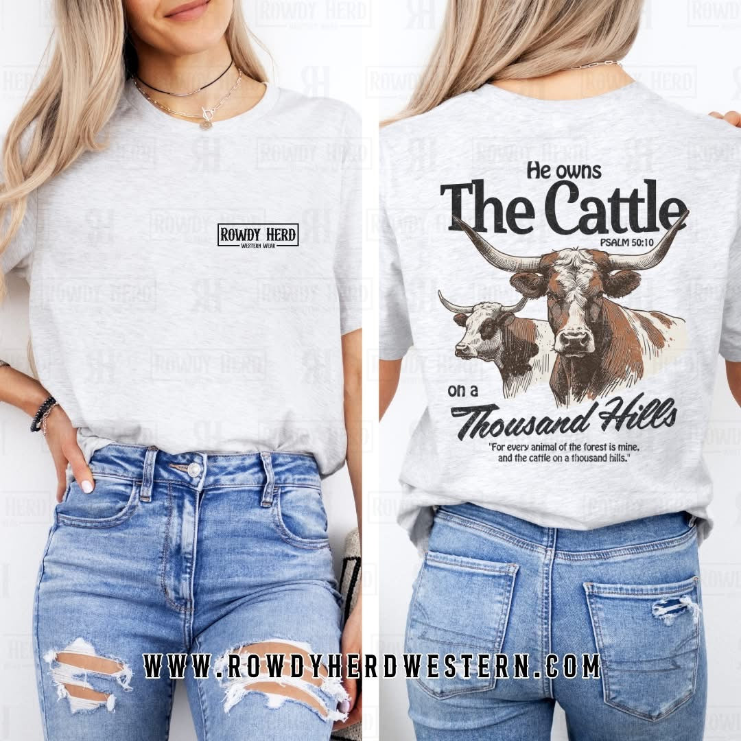 This heather grey Jerzees unisex t-shirt displays the Rowdy Herd logo on the front pocket area and a bold longhorn cattle graphic on the back, paired with the quote from Psalms 50:10.