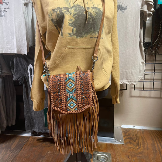 Brown crossbody purse with leather fringe, tooled leather, metal studs, and whipstitch detailing