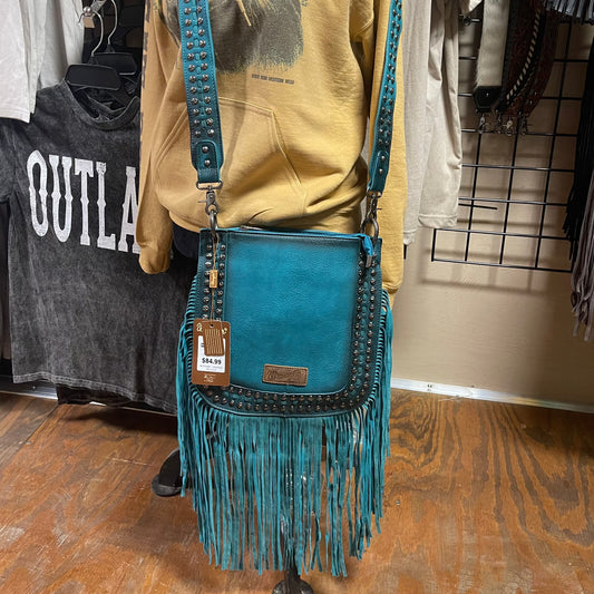 Turquoise crossbody bag with a double row of silver rivets and turquoise fringe 