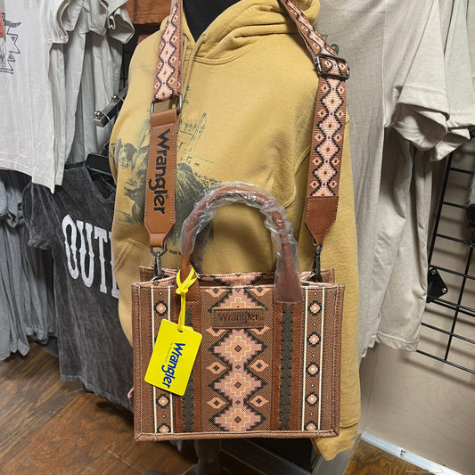 Crossbody/Tote with brown background and a aztec pattern overlay in creams, peaches and dark brown. Can be used with handles or with removable crossbody strap